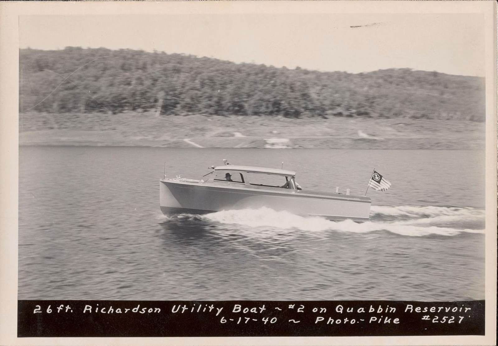 Black-and-white 1940 photo of a motorboat speeding across the Quabbin Reservoir