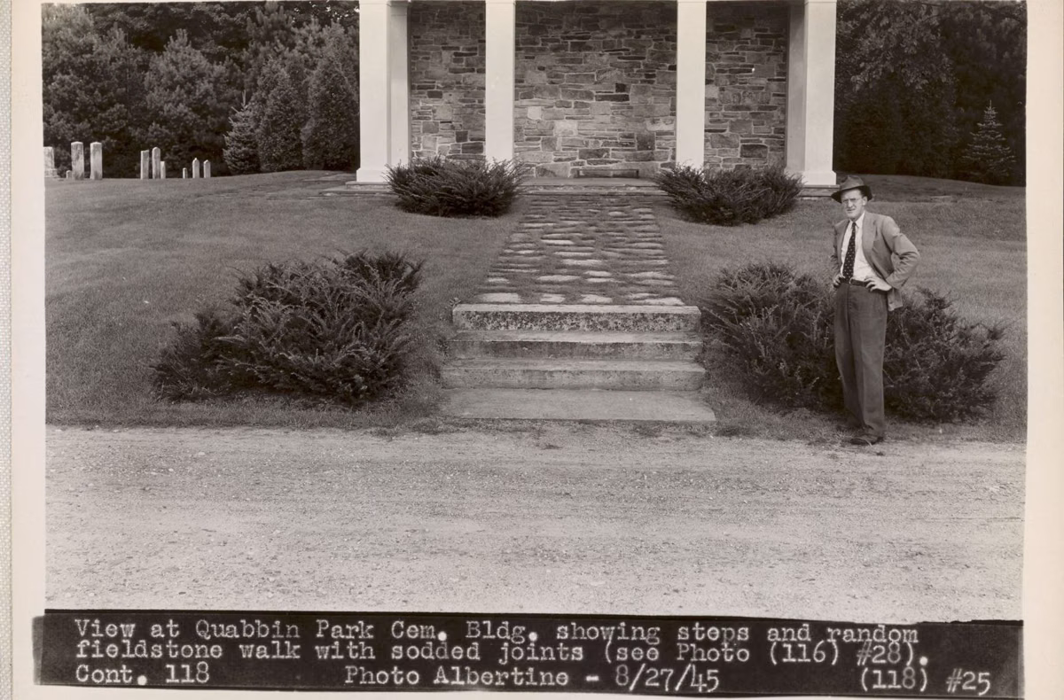 Black-and-white 1945 photo of the stone steps and walls at the Quabbin Park Cemetery building, with a man standing beside them